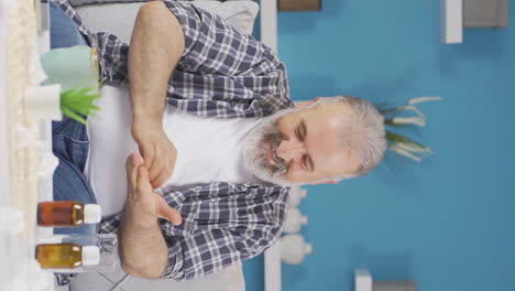 Vertical-video-of-Old-man-with-itchy-arms.